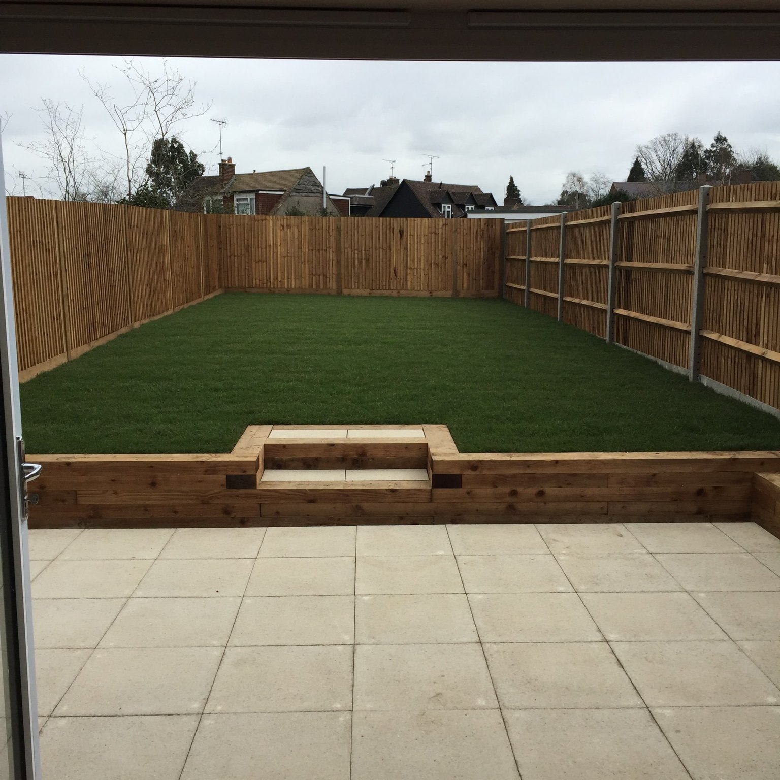 Borough Green buff slab patio, timber sleepers, new lawn and closeboard fencing